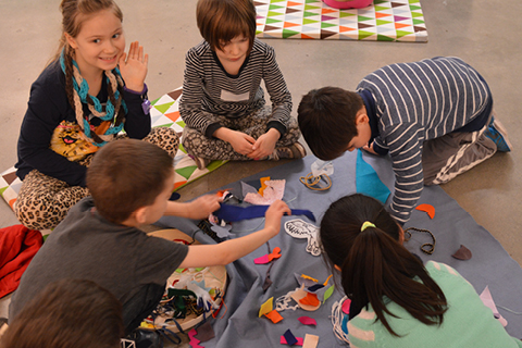 A group of young people working on an art collage