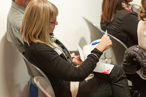 A person sitting in their seat looking over a brochure
