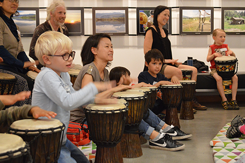 Young people and adults in the ArtStarts Gallery with drums