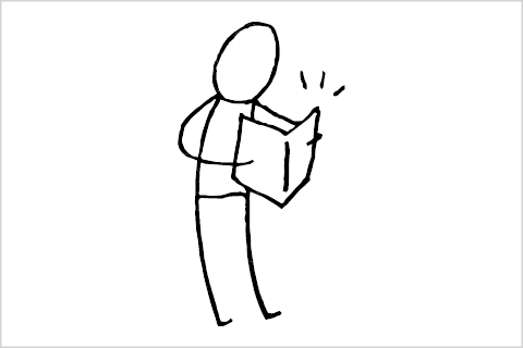 A stick figure reading a book